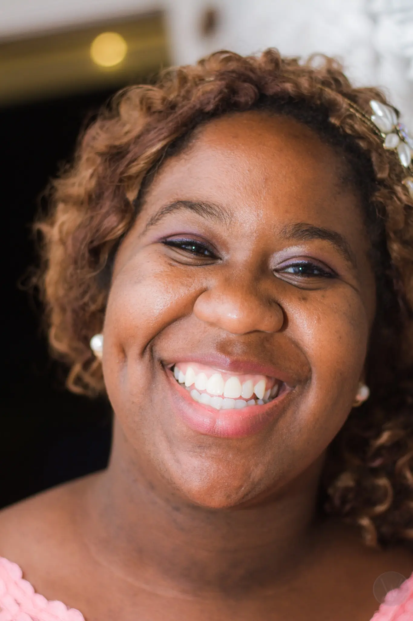 Smiling wedding guest with flowers in her hair