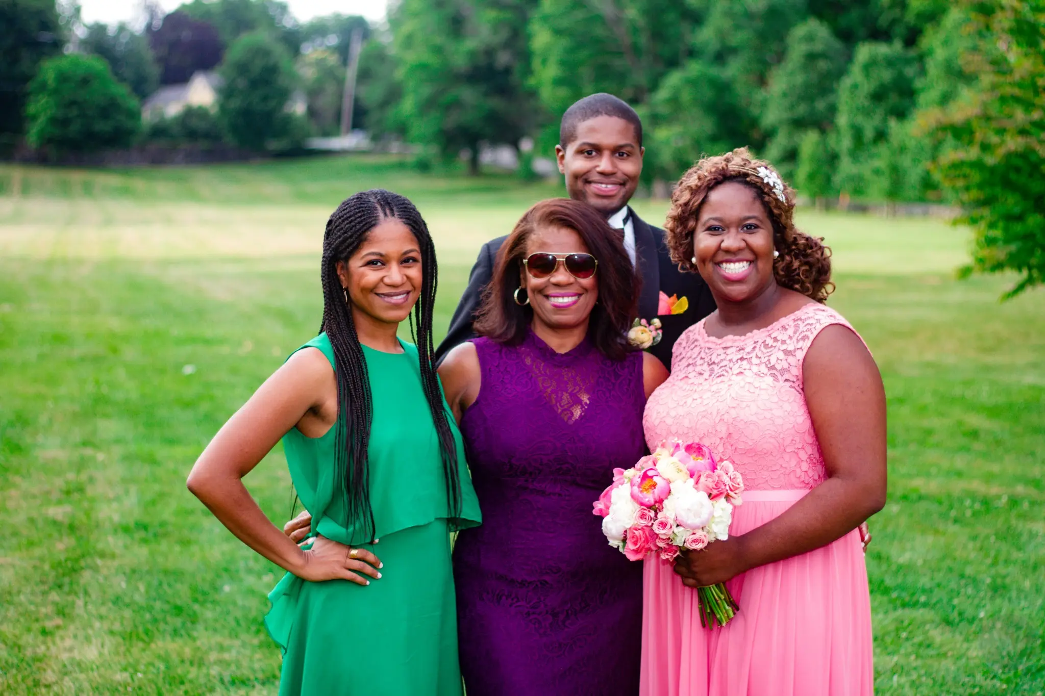 Three women from the wedding party posing outdoors