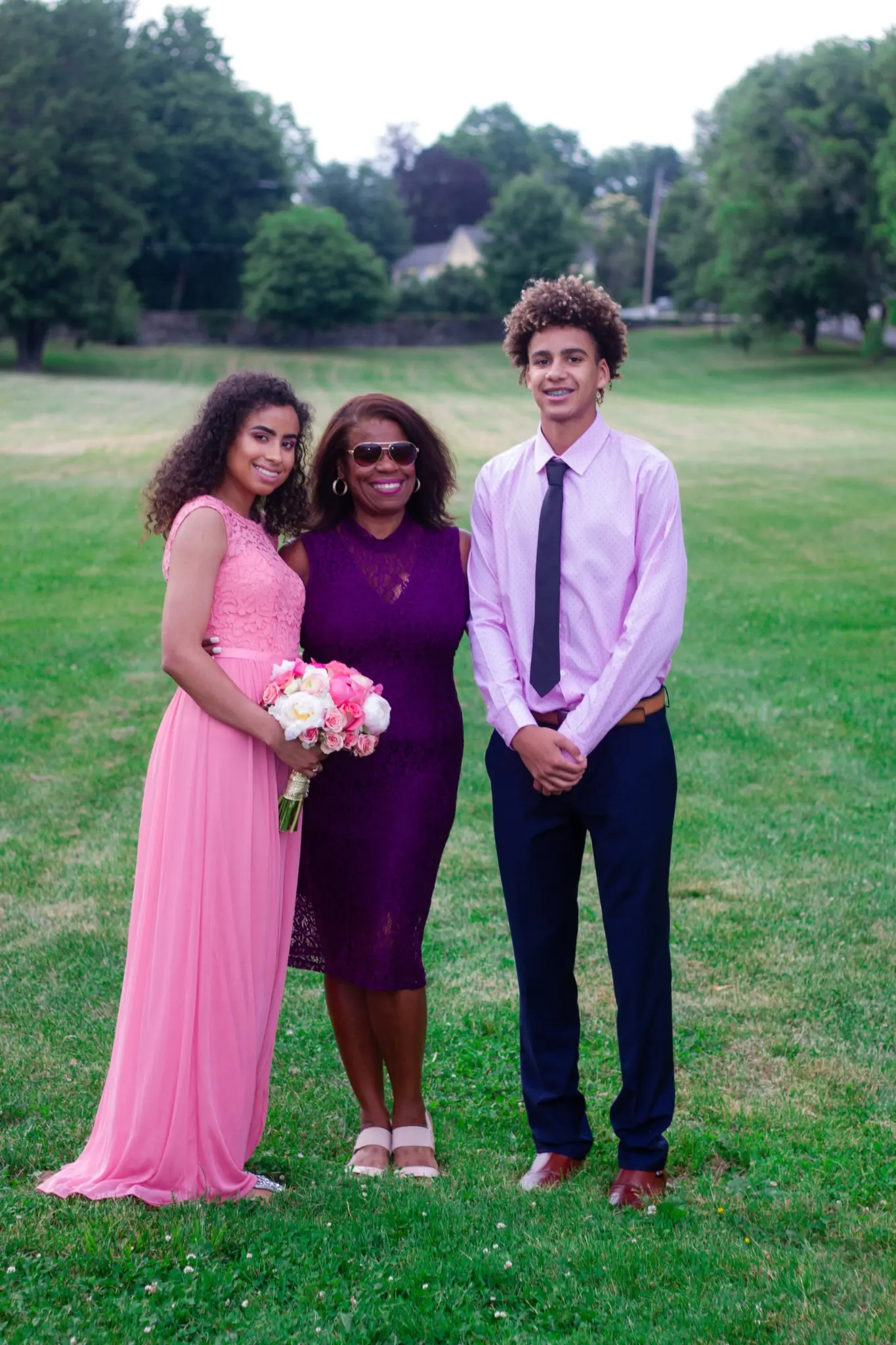 Wedding guests posing together on the lawn